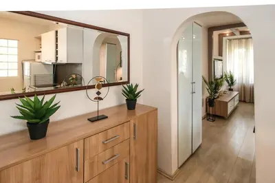 a room with a mirror and a dresser with plants on it at DELTA CITY New Belgrade Apartment free public parking in Belgrade
