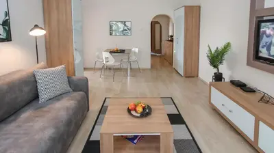 a living room with a couch and a table at DELTA CITY New Belgrade Apartment free public parking in Belgrade