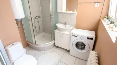 a bathroom with a washing machine and a sink at DELTA CITY New Belgrade Apartment free public parking in Belgrade