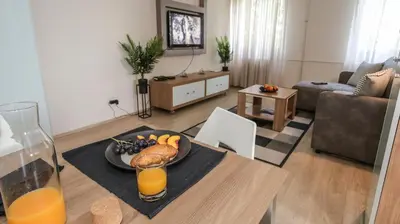 a living room with a table with a plate of food at DELTA CITY New Belgrade Apartment free public parking in Belgrade