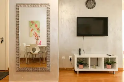 a living room with a mirror and a table at New Belgrade Apartment Lavina, parking 5 evra dan in Belgrade