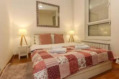a bedroom with a bed with two towels on it at New Belgrade Apartment Lavina, parking 5 evra dan in Belgrade