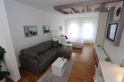 a living room with a couch and a table at New Belgrade Apartment Belville, parking 5 evra dan in Belgrade