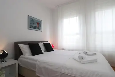 a bedroom with two beds with towels on them at New Belgrade Apartment Belville, parking 5 evra dan in Belgrade
