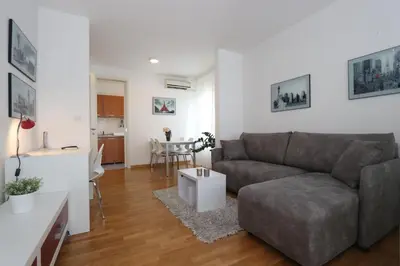 a living room with a couch and a table at New Belgrade Apartment Belville, parking 5 evra dan in Belgrade