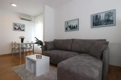 a living room with a couch and a table at New Belgrade Apartment Belville, parking 5 evra dan in Belgrade