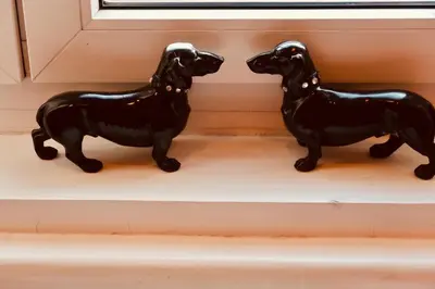 two black dog figurines sitting on a window sill at Belle Apartments - Obilicev Venac in Belgrade