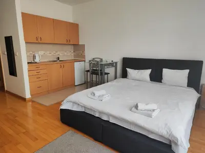 a bedroom with a large bed with two towels on it at Belle Apartments-Elegance Apartments in Belgrade