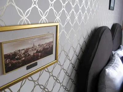a picture frame on a wall next to a bed at Belle Apartments-Elegance Apartments in Belgrade