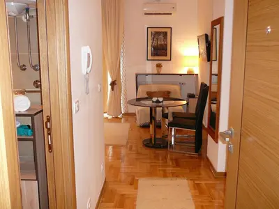 a hallway with a table and a desk in a room at Belle Apartments - Luxury Apartments in Belgrade