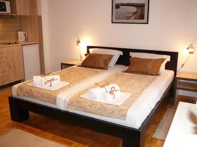 a bedroom with a large bed with two towels at Belle Apartments - Luxury Apartments in Belgrade