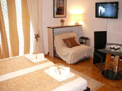 a living room with a bed and a table at Belle Apartments - Luxury Apartments in Belgrade