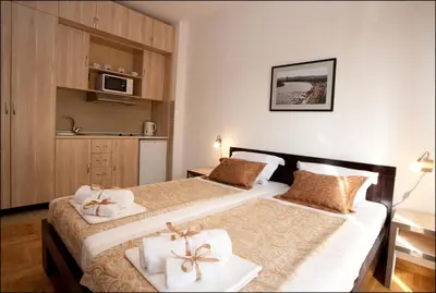 two beds in a hotel room with towels on them at Belle Apartments - Luxury Apartments in Belgrade