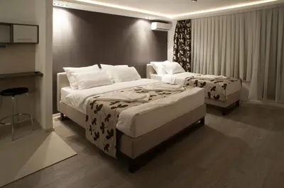 a hotel room with two beds and a table at Apartments Villa Savamala in Belgrade