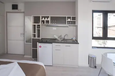 a kitchen with white cabinets and a sink at Apartments Villa Savamala in Belgrade