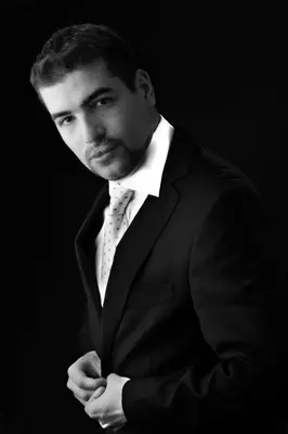 a man in a suit and tie with his arms crossed at Downtown Belgrade Apartments - CHERRY in Belgrade