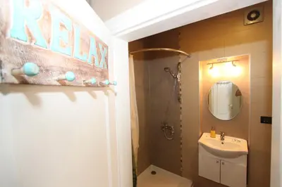 a bathroom with a sink and a toilet and a mirror at Sneki Apartment in Belgrade