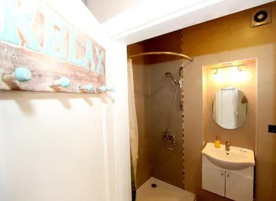 a bathroom with a sink and a toilet and a mirror at Sneki Apartment in Belgrade