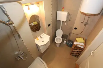 a small bathroom with a toilet and a sink at Sneki Apartment in Belgrade