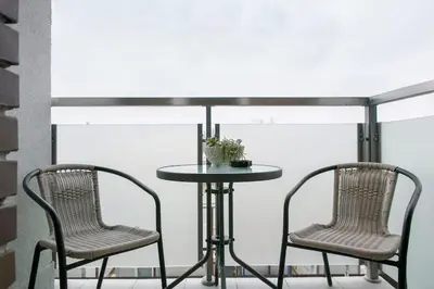 two chairs and a table and a table and chairs at Apartman Cezar in Belgrade