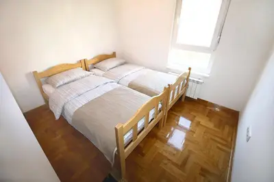two beds in a small bedroom with a window at Shining in Belgrade