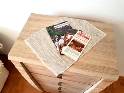 a table with a newspaper on top of it at Shining in Belgrade