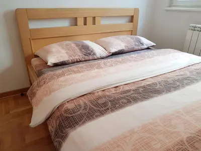 a bed with two pillows on top of it at Shining in Belgrade