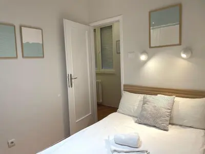 a bedroom with a bed with a towel on it at City Break Apartments Klishe Zen in Belgrade