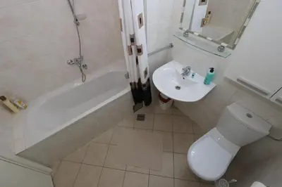 a bathroom with a toilet and a sink and a tub at Clean&Cozy Apartments Novi Beograd in Belgrade