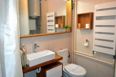 a bathroom with a sink and a toilet and a mirror at Clean&Cozy Apartments Novi Beograd in Belgrade