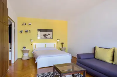 a living room with a bed and a couch at Apartment Downtown Atelje in Belgrade