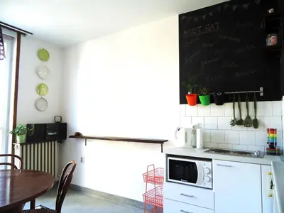a kitchen with a table and a blackboard on the wall at Apartment Downtown Atelje in Belgrade