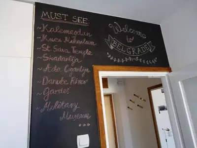 a chalkboard on the wall of a room withcriptions at Apartment Downtown Atelje in Belgrade