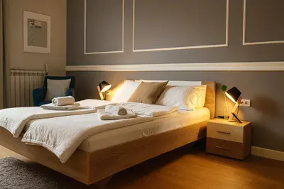 a bedroom with a bed with two towels on it at City Break Apartments - City Zen in Belgrade