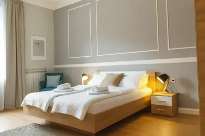a bedroom with a large bed with two towels on it at City Break Apartments - City Zen in Belgrade
