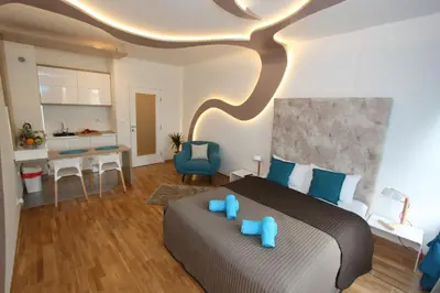 a bedroom with a large bed with blue pillows at Riviera 2 New Belgrade studio apartment, parking 5 evra dan in Belgrade