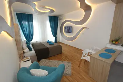a living room with a blue chair and a couch at Riviera 2 New Belgrade studio apartment, parking 5 evra dan in Belgrade