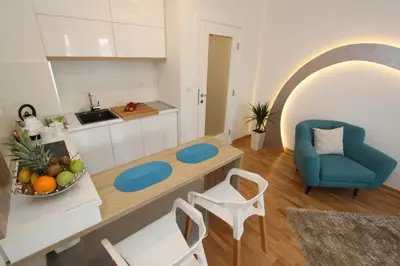 a kitchen and living room with a table and chairs at Riviera 2 New Belgrade studio apartment, parking 5 evra dan in Belgrade