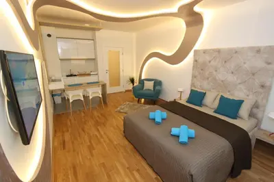 a hotel room with a bed and a desk and a room at Riviera New Belgrade apartment, parking 5 eur per day in Belgrade