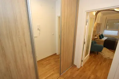 a hallway leading to a bedroom with a mirror at Riviera New Belgrade apartment, parking 5 eur per day in Belgrade