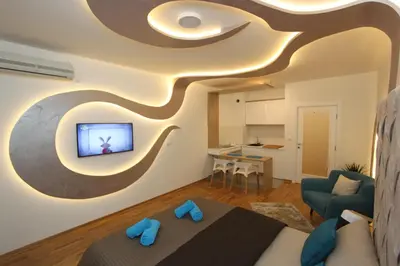a living room with a couch and a tv on a ceiling at Riviera New Belgrade apartment, parking 5 eur per day in Belgrade