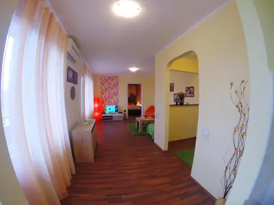 a hallway leading to a living room with wood floors at Balkan-inn Skadarlija 2 apartment in Belgrade