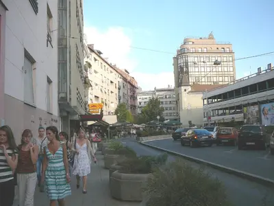 a group of people walking down a sidewalk on a city street at Balkan-inn Studio Centar apartment in Belgrade