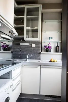 a kitchen with white cabinets and a sink at Balkan-inn Studio Centar apartment in Belgrade