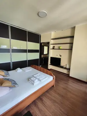 a bedroom with a large bed with towels on it at Balkan-inn Studio Centar apartment in Belgrade