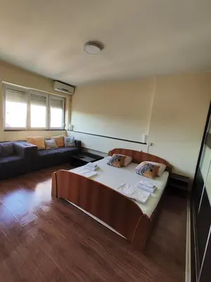a living room with a bed and a couch at Balkan-inn Studio Centar apartment in Belgrade