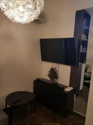 a living room with a flat screen tv on the wall at Balkan-inn Parlament Lux apartment in Belgrade