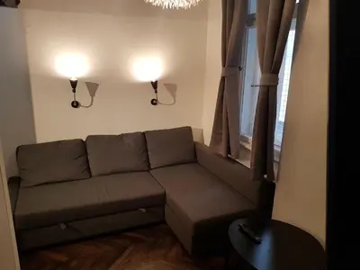 a living room with a couch and a window at Balkan-inn Parlament Lux apartment in Belgrade