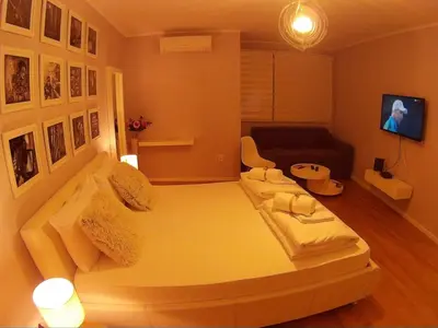 a small living room with a couch and a bed at Balkan-inn Parlament Lux apartment in Belgrade