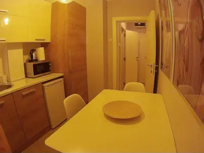 a small kitchen with a table with a plate on it at Balkan-inn Parlament Lux apartment in Belgrade